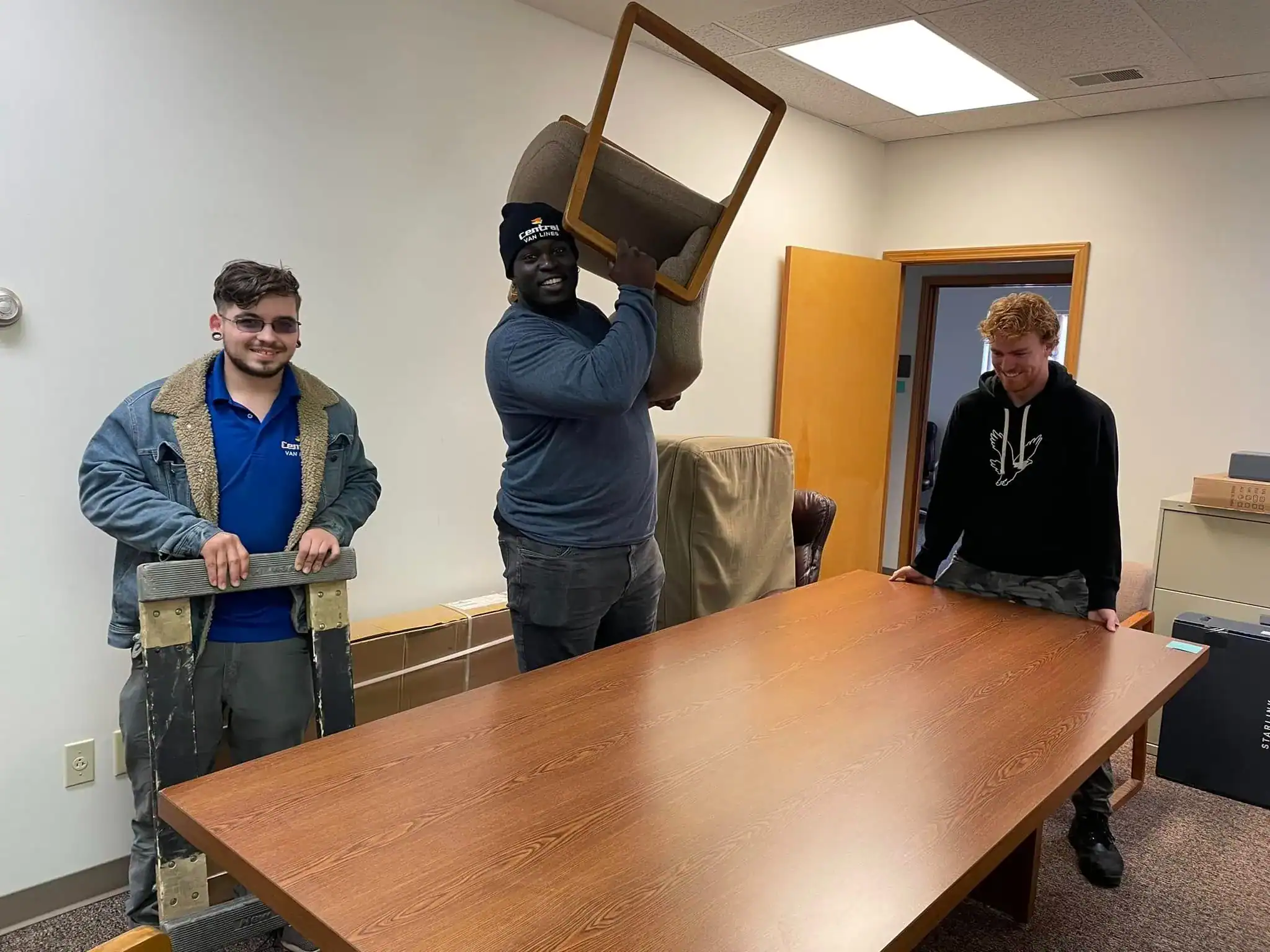 Central Van Lines movers carrying office furniture