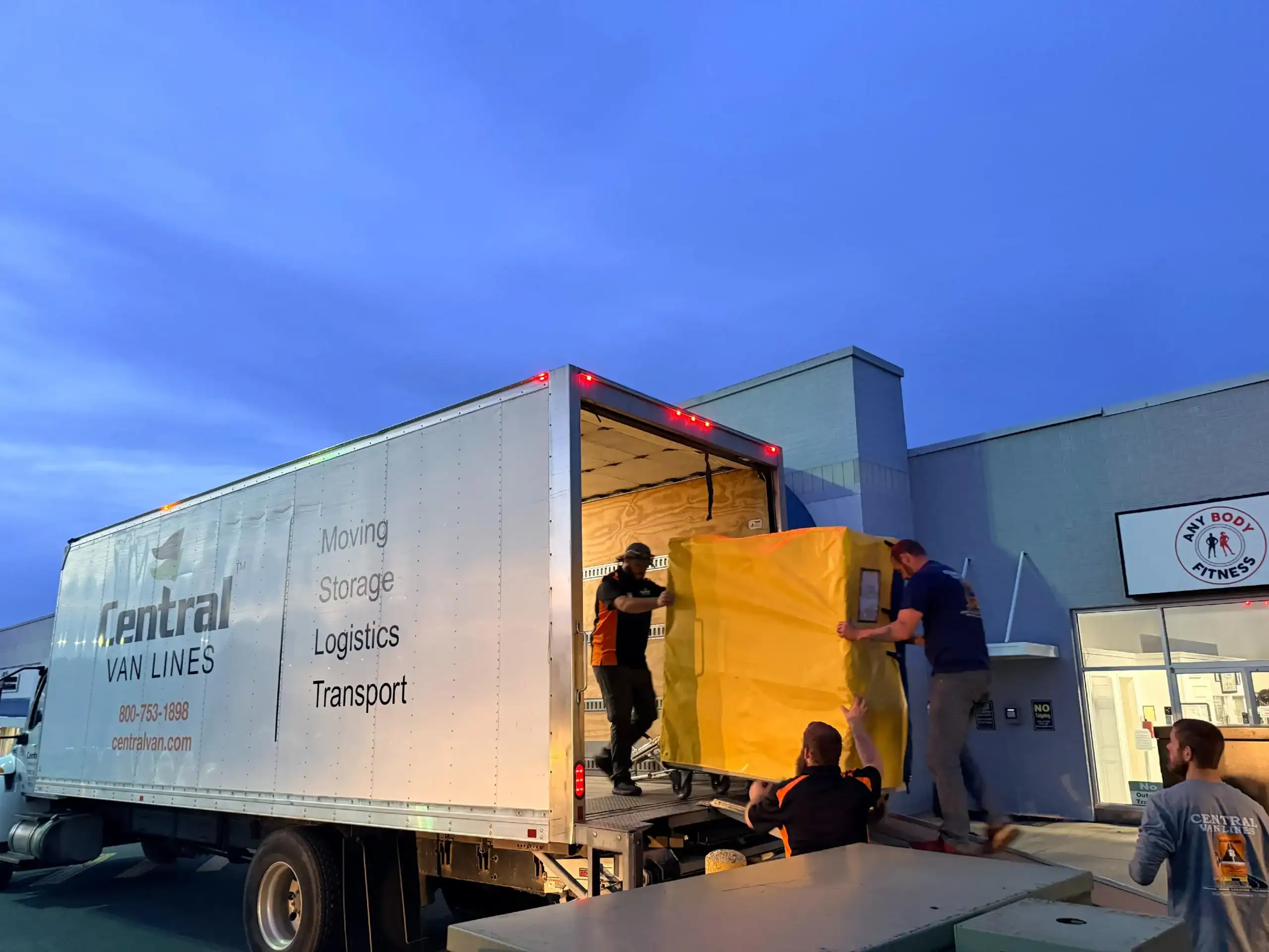 Central Van Lines crew loading wrapped furniture onto truck