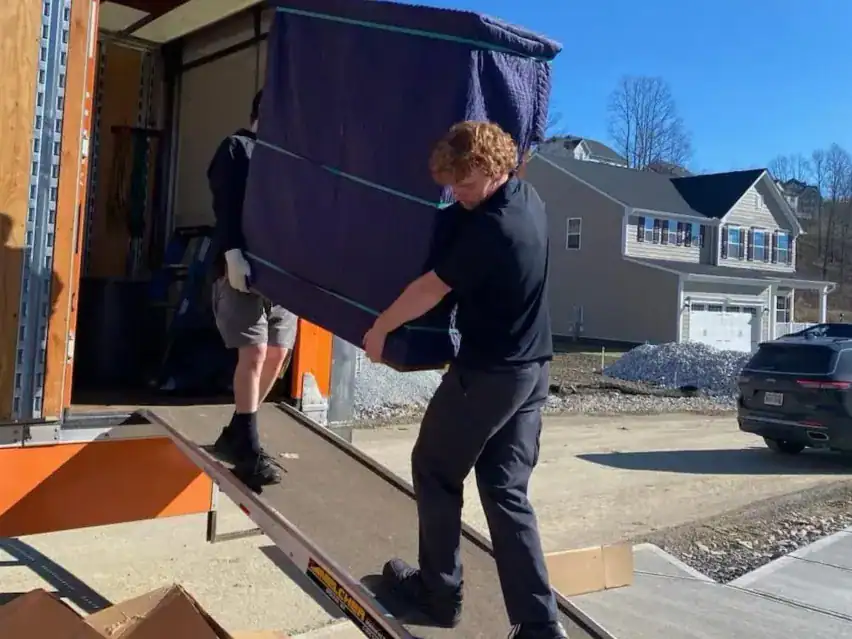 Mover unloading furniture from a Central Van Lines truck